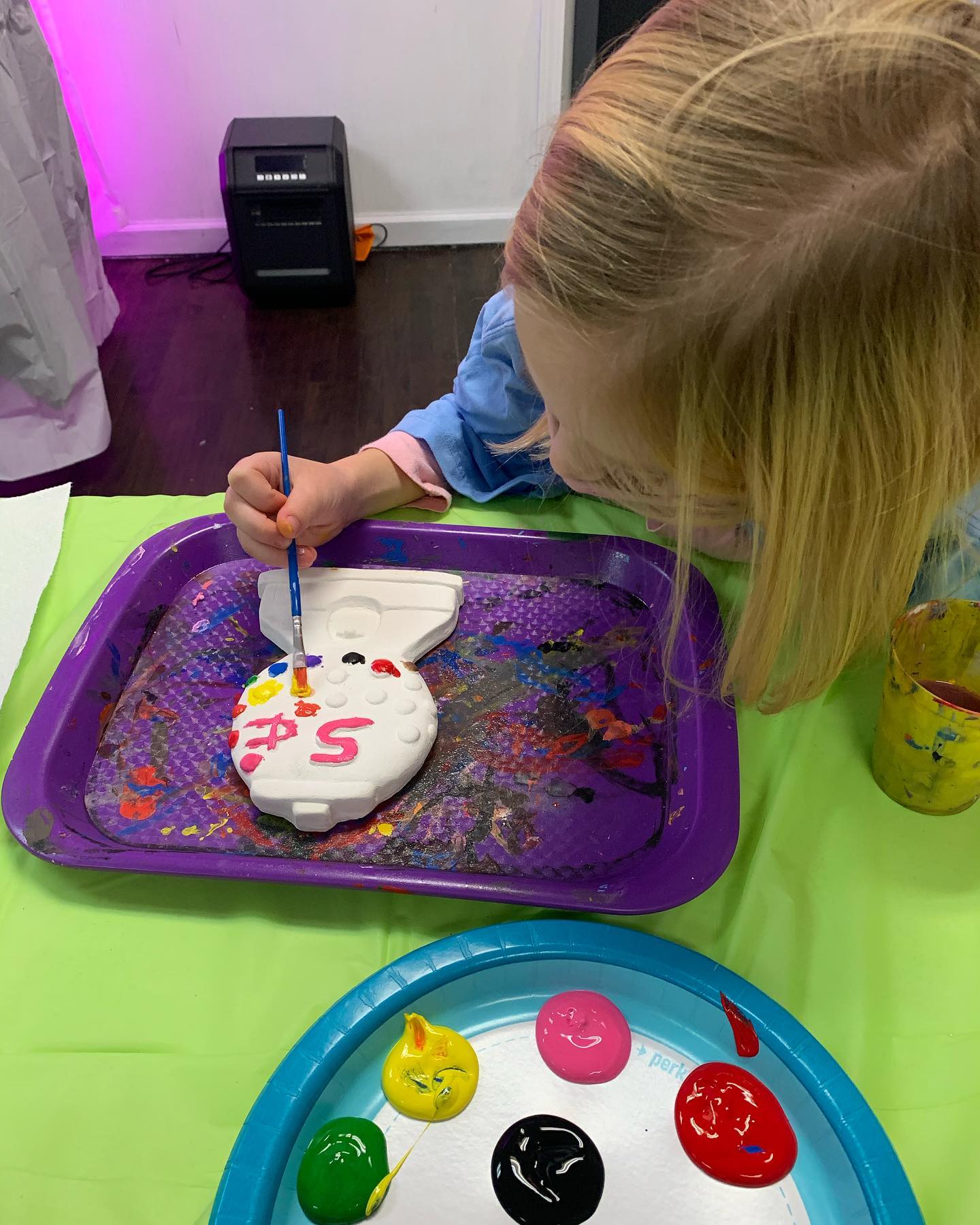 Girl painting gumball machine plaster party piece