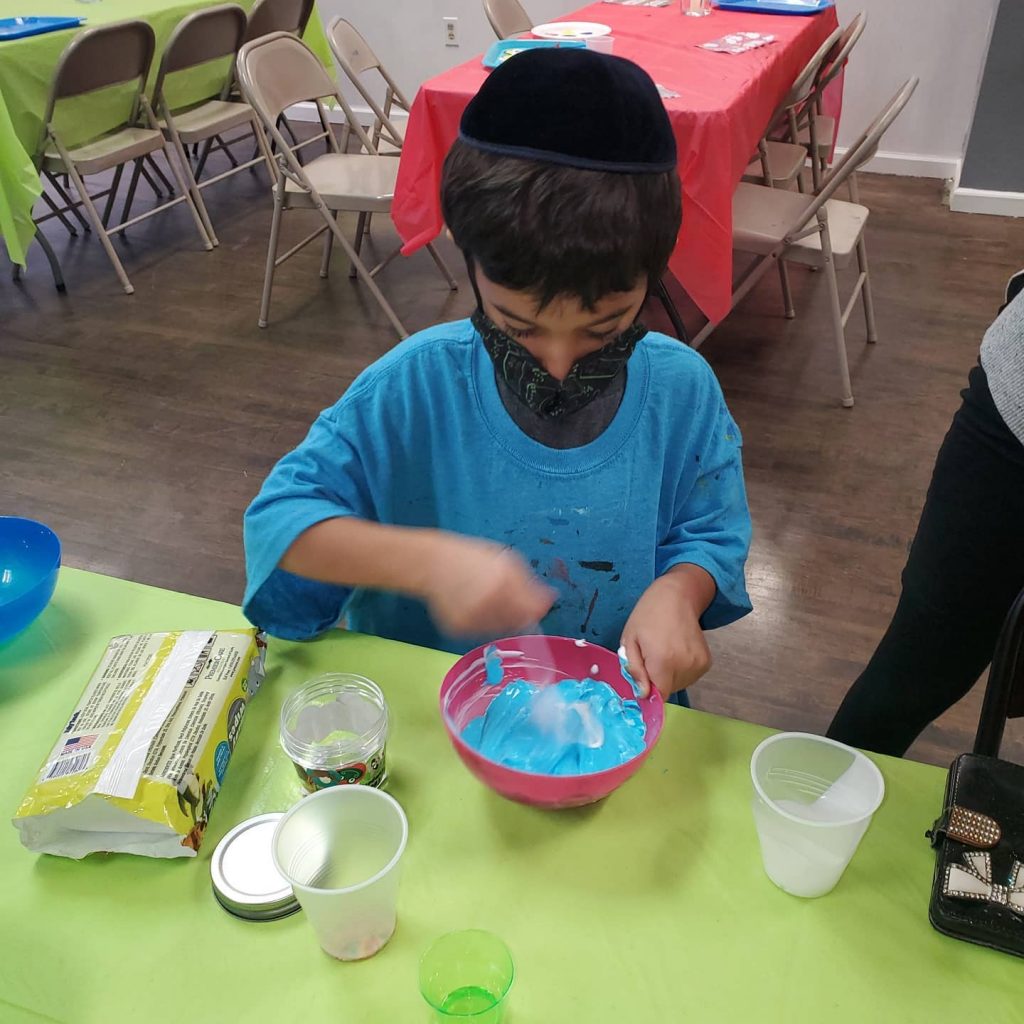 Boy in mask making slime