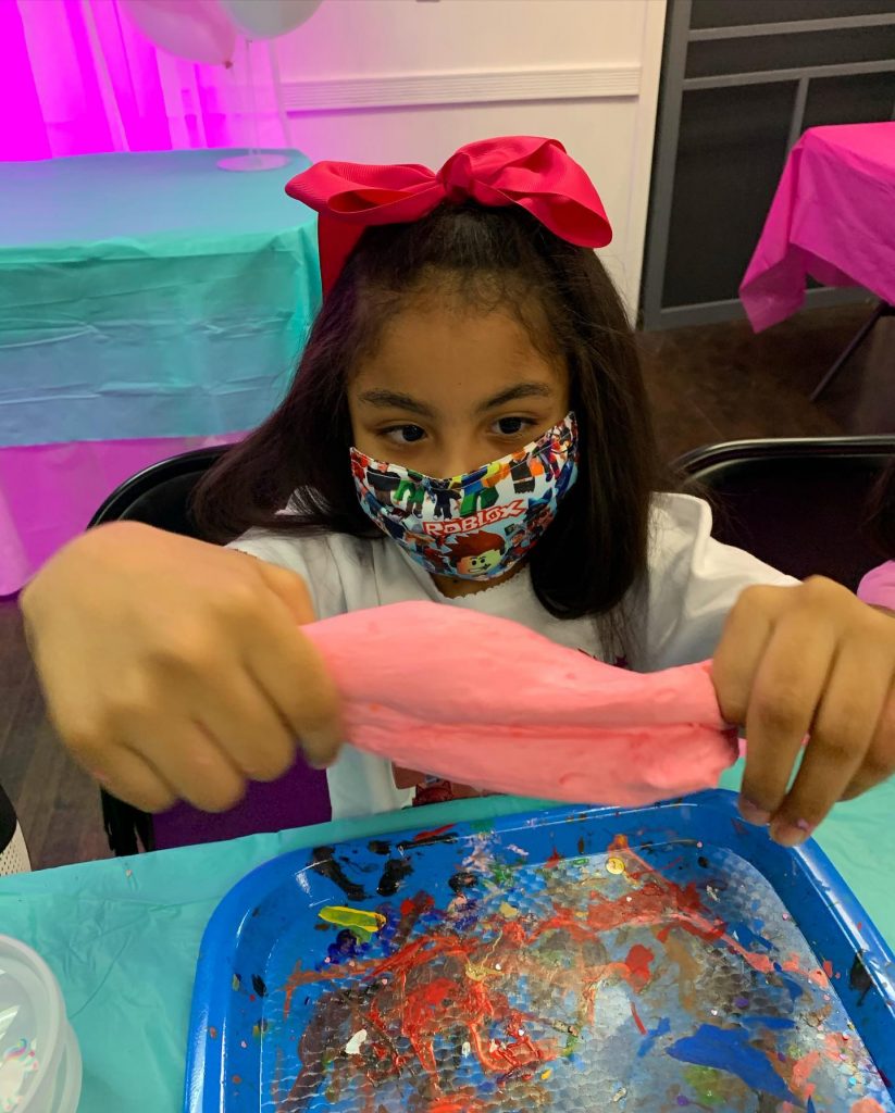 Girl in mask making slime