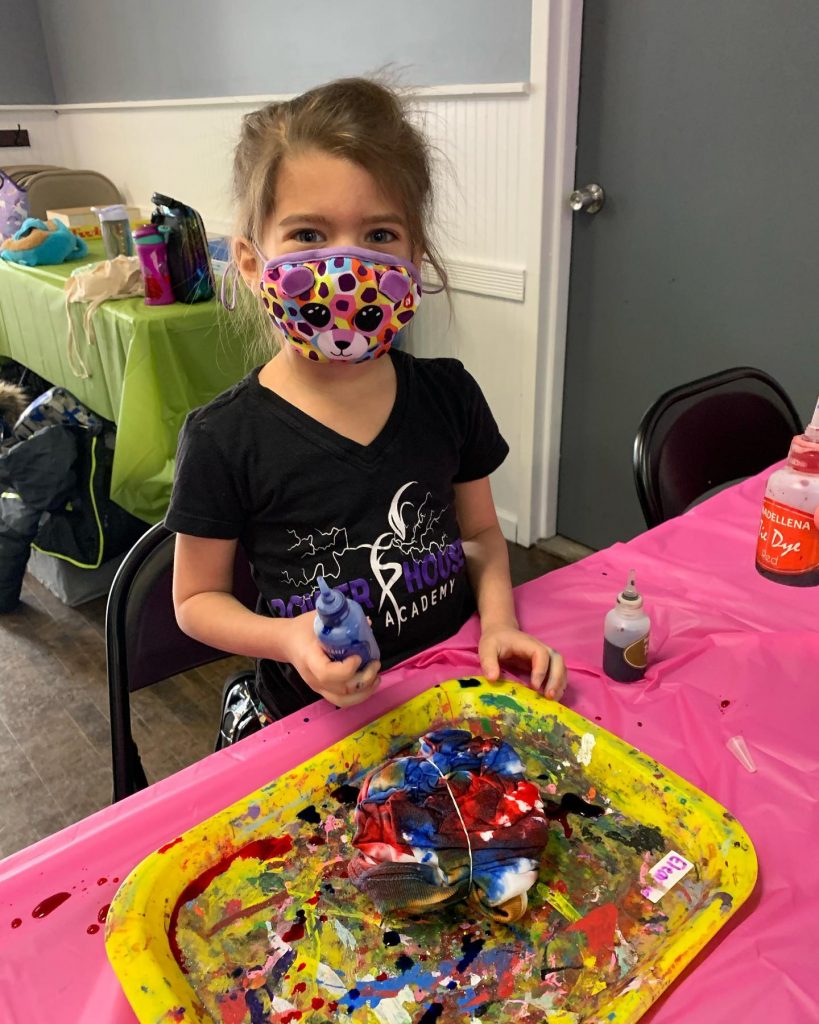 Cute girl in mask making tie dye