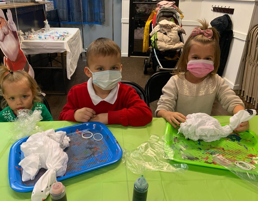 Children in masks getting ready for tie dye party