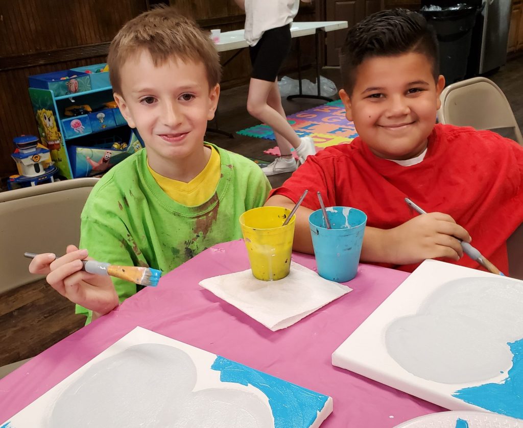 Boys painting during paint party