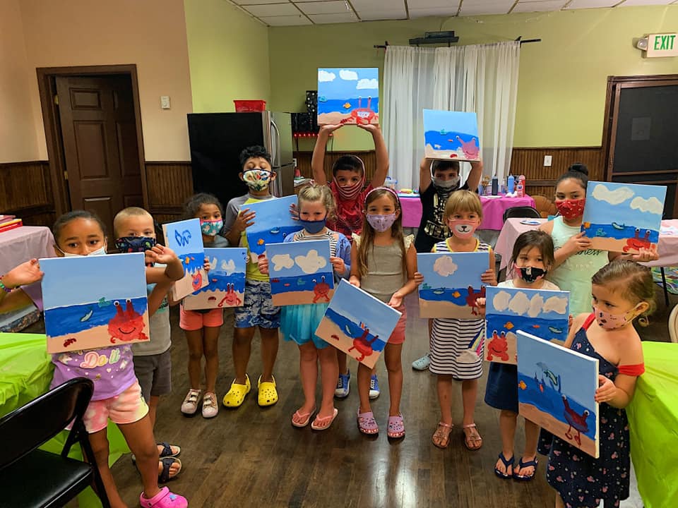 Children in masks showing crab on beach canvas painting