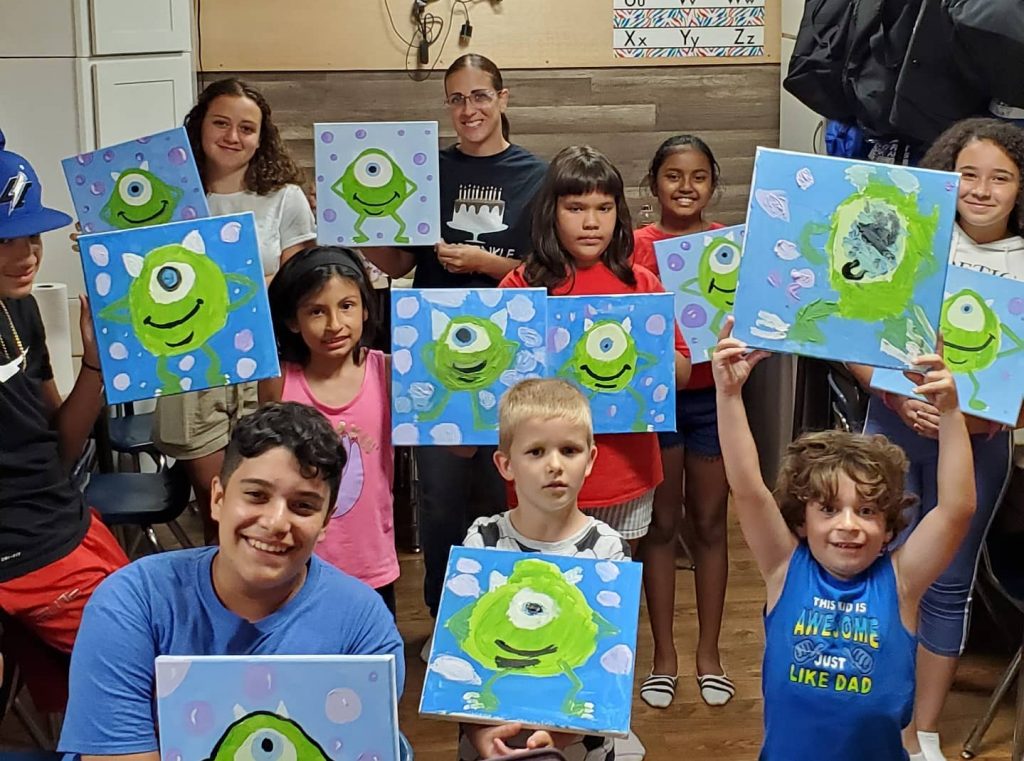 Kids showing Monster themed canvas paintings